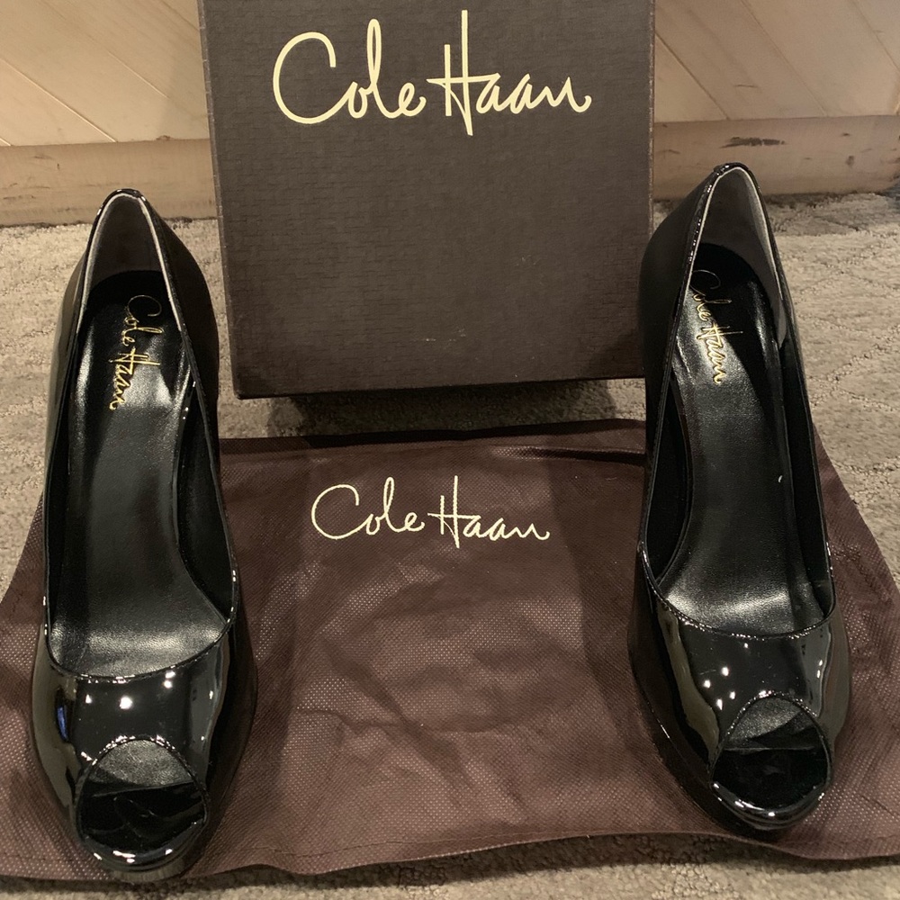 Cole Haan black patent leather peep toe pumps.